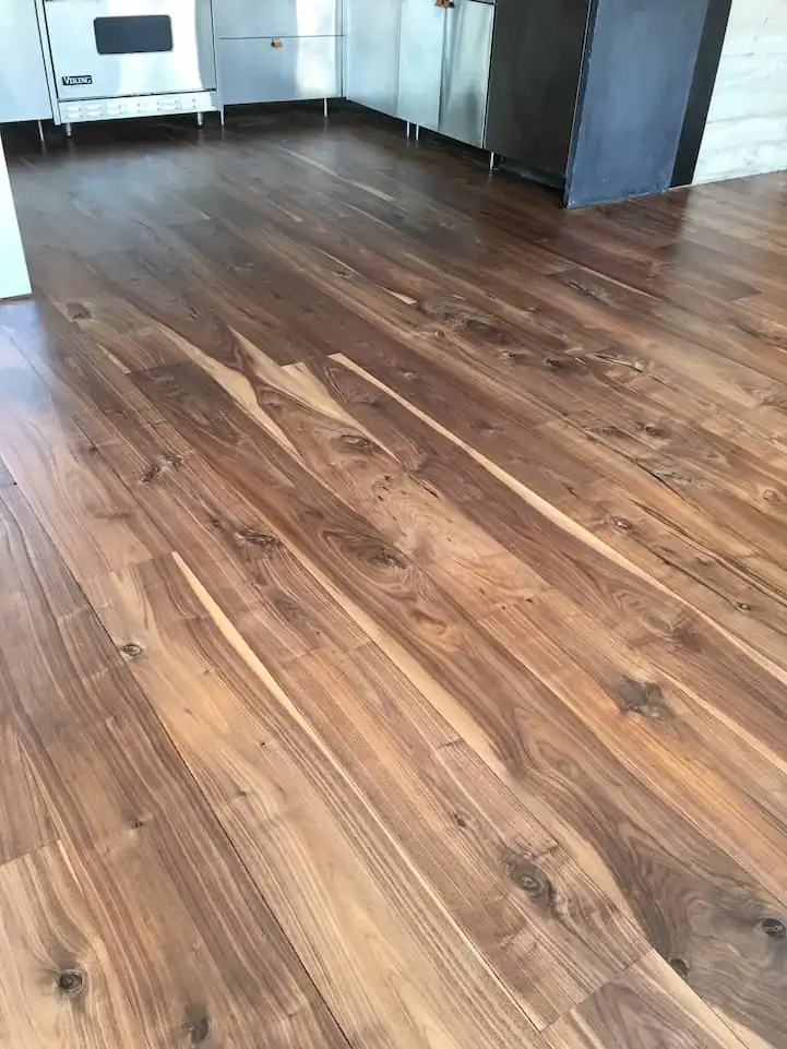Professional laminate floor installation featuring realistic wood-look planks, tight seams, and a durable, low-maintenance surface.
